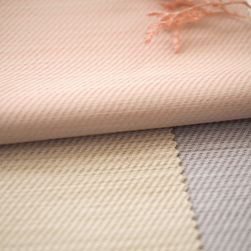 生地のアップ画像です。繊細な織りのニュアンスが光の当たり方によって表情を変え、空間に自然な奥行きと豊かさを演出します。